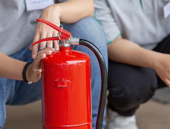 person holding a fire extinguisher during safety training three tips for fire safety